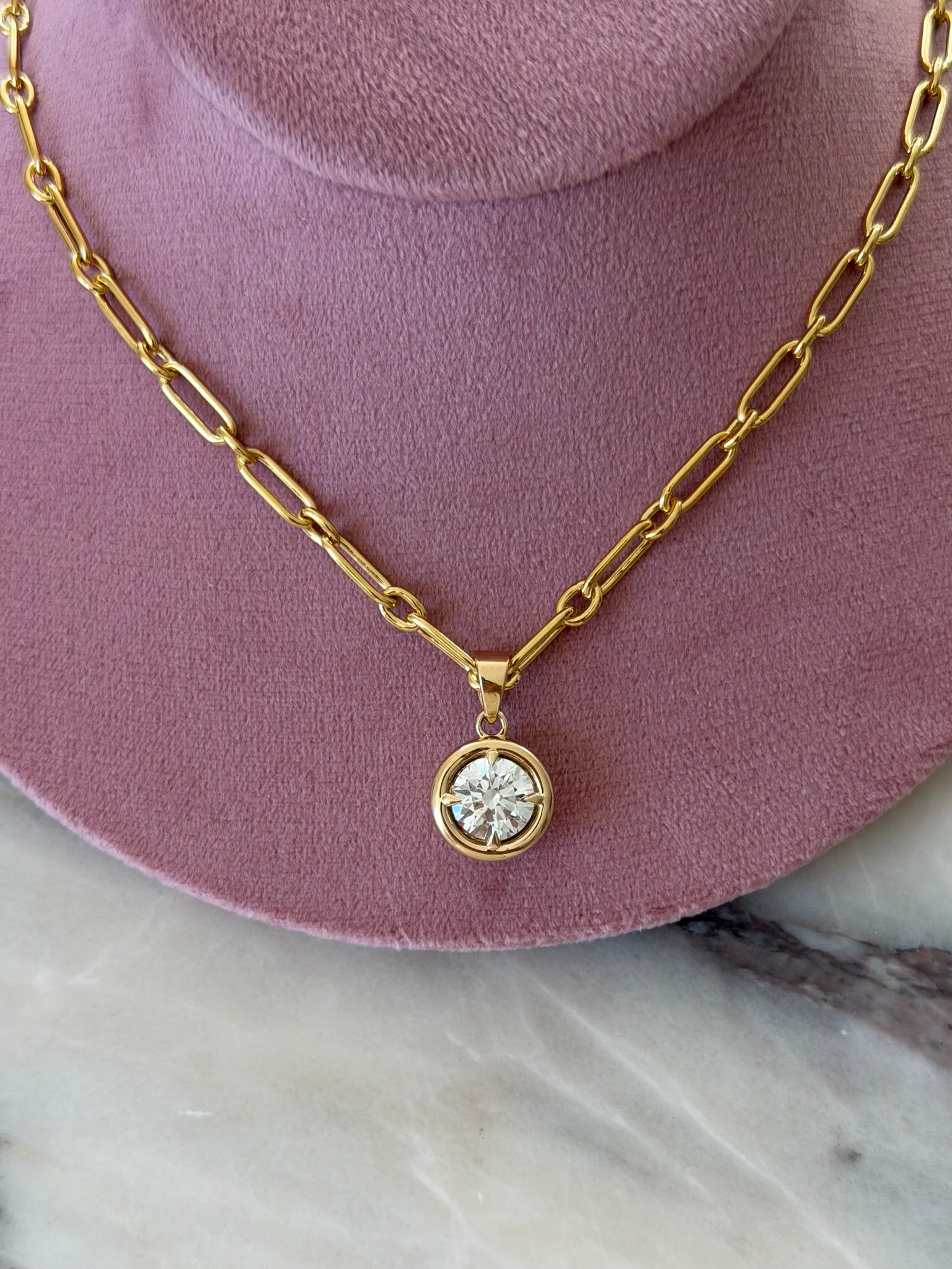 Daily Diamonds gold necklace with a round diamond pendant 